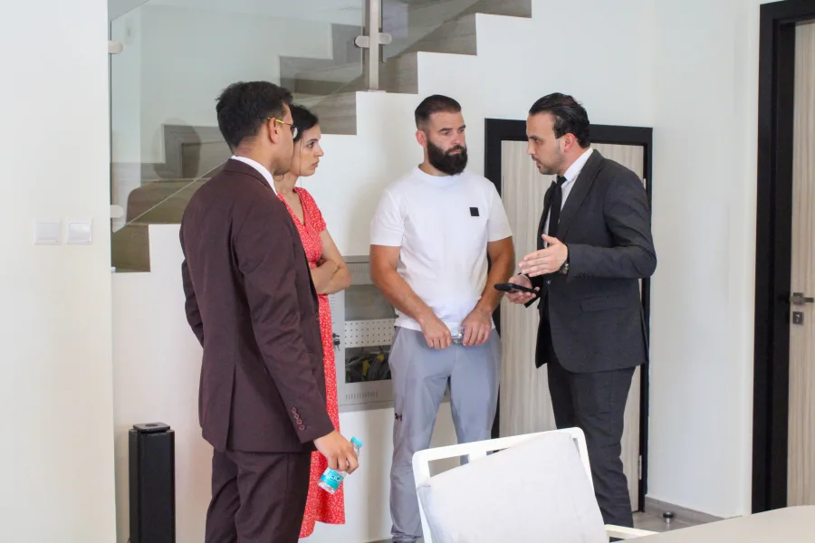 A real estate agent advising a family who wants to invest in dubai about the property and why they should invest in dubai